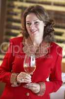 Woman Having A Glass Of Wine At A Bar