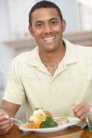 Man Enjoying A Meal At Home