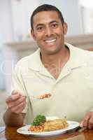 Man Enjoying A Meal At Home