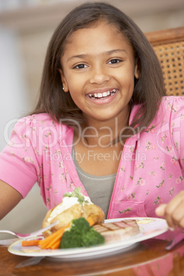 Young Girl Enjoying A Meal At Home