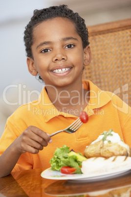 Young Boy Enjoying A Meal At Home