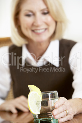 Woman Having A Drink At Home