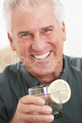 Man Having A Drink At Home