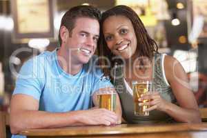 Couple Drinking Beer Together In A Pub