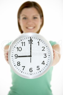 Woman Holding Clock Showing 9 O'Clock