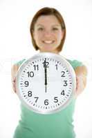 Woman Holding Clock Showing 12 O'Clock