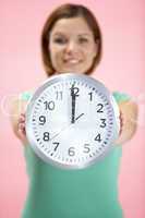 Woman Holding Clock Showing 12 O'Clock