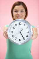 Woman Holding Clock Showing 5 O'Clock