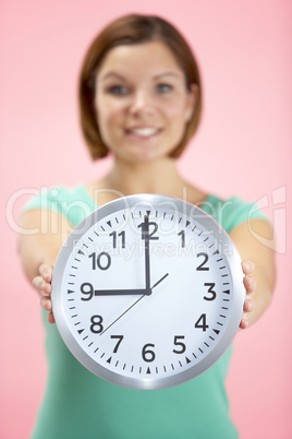 Woman Holding Clock Showing 9 O'Clock