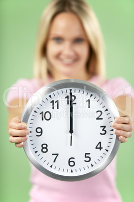 Woman Holding Clock Showing 12 O'Clock