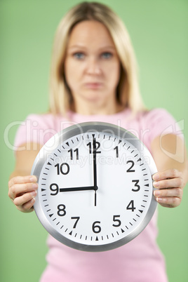 Woman Holding Clock Showing 9 O'Clock