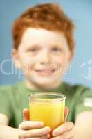 Young Boy Holding Glass Of Juice