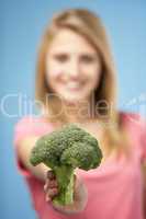 Teenage Girl Holding Fresh Broccoli