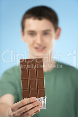 Teenage Boy Holding Bar Of Chocolate