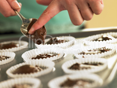 Putting Chocolate Cupcake Mix Into Baking Tin