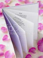 Wedding Booklet Surrounded By Rose Petals