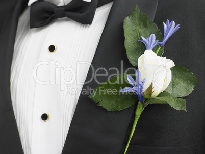 Man Wearing A Suit With A White Rose Corsage