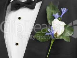 Man Wearing A Suit With A White Rose Corsage