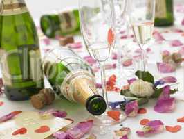 Empty Wine Bottles Among Rose Petals