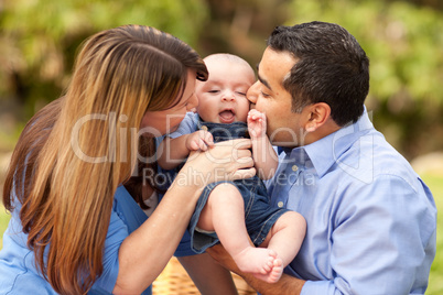 Happy Mixed Race Parents Playing with Their Son