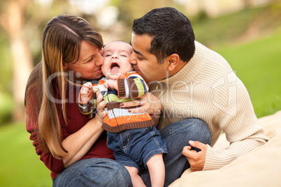 Happy Mixed Race Parents Playing with Their Son