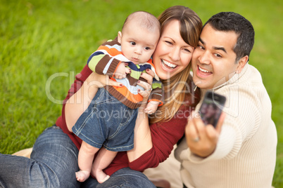 Happy Mixed Race Parents and Baby Boy Taking Self Portraits