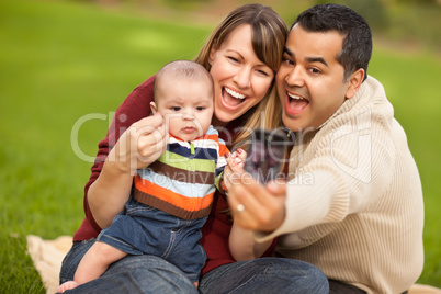 Happy Mixed Race Parents and Baby Boy Taking Self Portraits