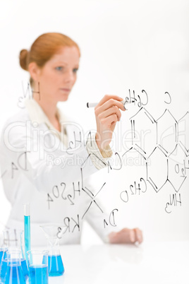Woman scientist in laboratory write chemical formula