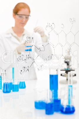 Woman scientist in laboratory with microscope