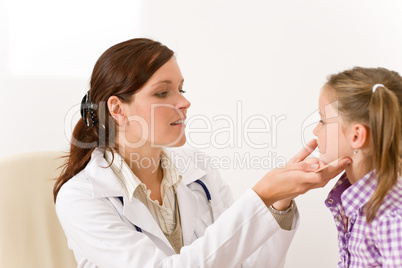 Female doctor examining child with sore throat