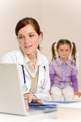 Female doctor write prescription for child