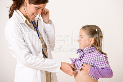 Female doctor examining child with stethoscope