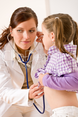 Female doctor examining child with stethoscope