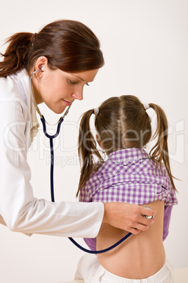 Female doctor examining child with stethoscope