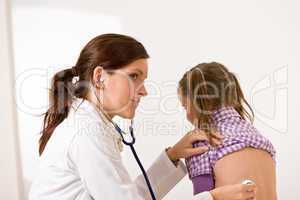 Female doctor examining child with stethoscope