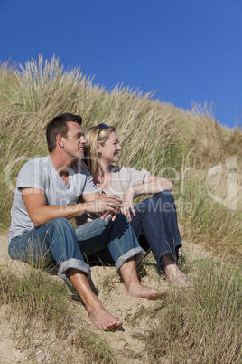 Romantic Man and Woman Couple Sitting Together On A Beach