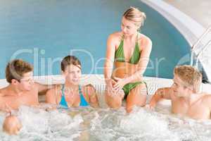 Swimming pool - happy people relax in hot tub