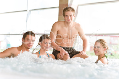 Swimming pool - happy people relax in hot tub