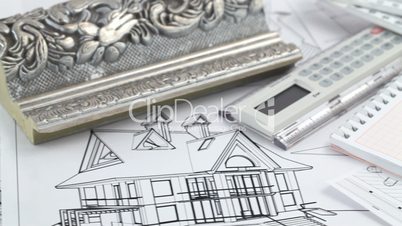 notepad, pen and architectural drawings