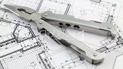pliers and architectural blueprints