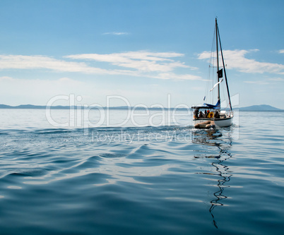 White yacht sailing on calm sea