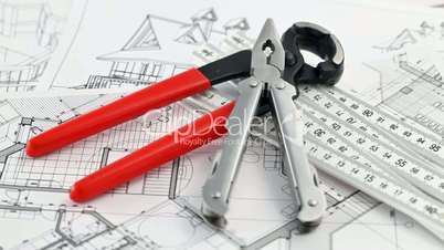 pliers, nail puller & architectural blueprints