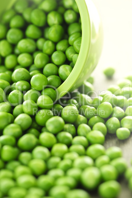 Spilled bowl of green peas