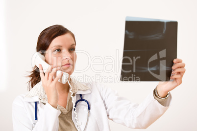 Female doctor with x-ray and phone