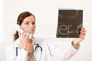 Female doctor with x-ray and phone
