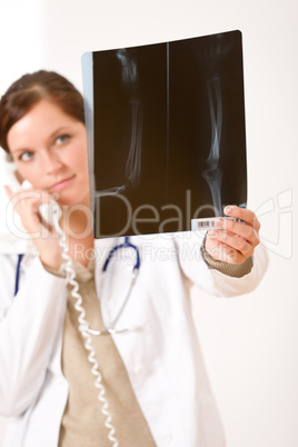 Female doctor with x-ray and phone