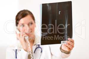 Female doctor with x-ray and phone