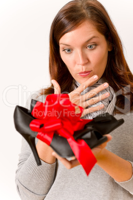 Surprised woman holding present shoes