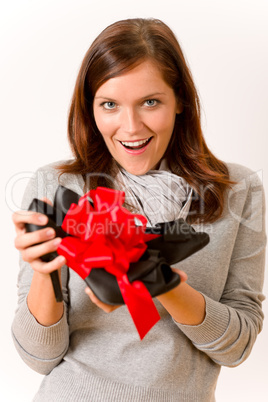 Surprised woman holding present shoes