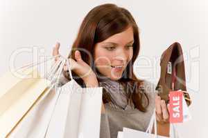 Shopping - woman holding shoes and bags